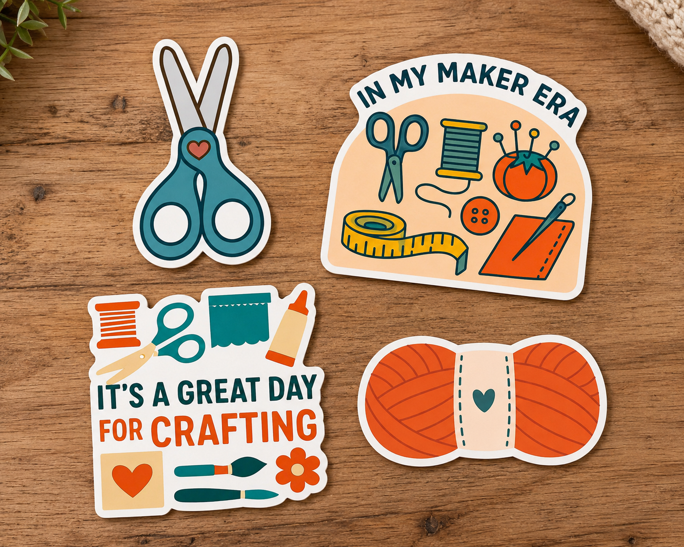 Four colorful craft-themed stickers on a wooden table