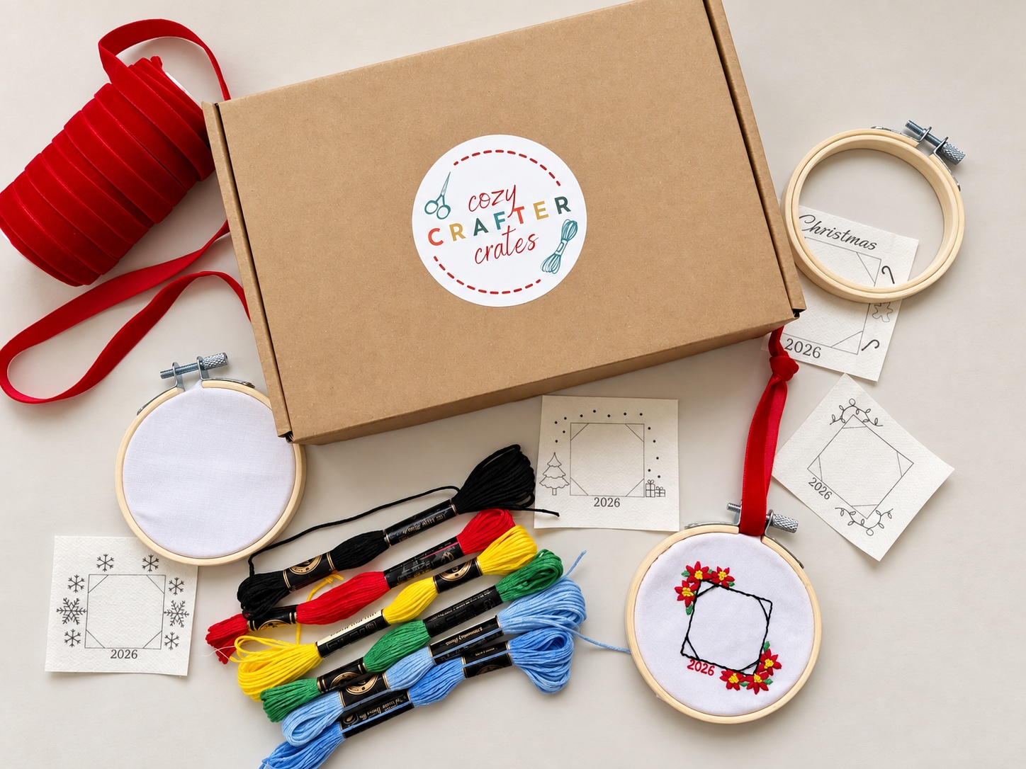 What's inside Mom's Holiday Embroidery Kit β hoops, floss, ribbon, templates, and instructions Mom's Holiday Embroidery Kit laid out with hoops, festive embroidery floss, ribbon, templates, and the branded craft box