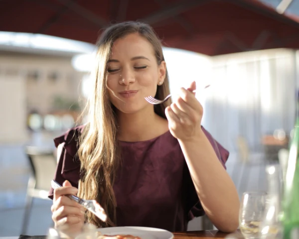 Person enjoying a meal outdoors
