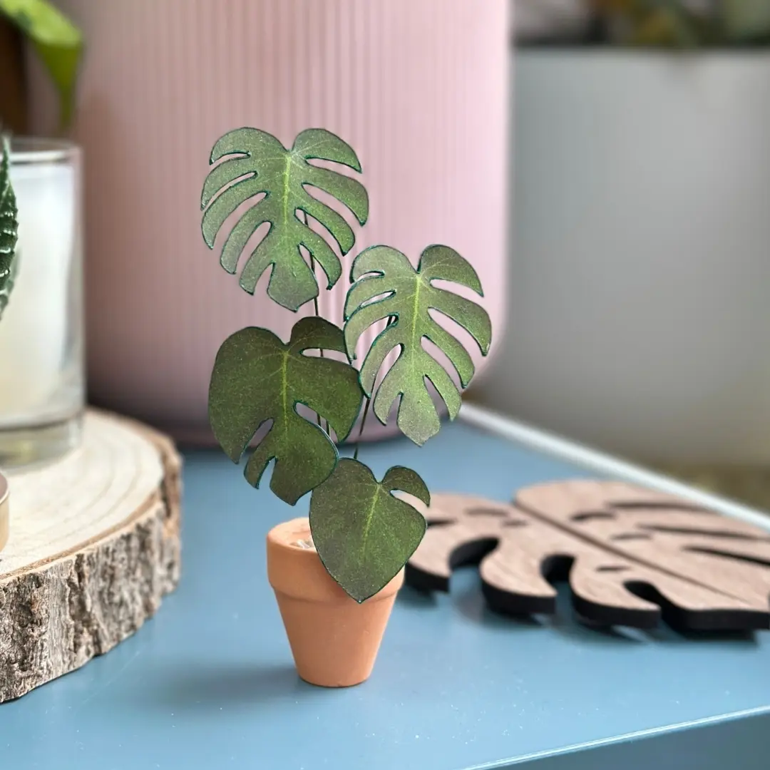 Miniature paper Monstera plant in a tiny terracotta pot