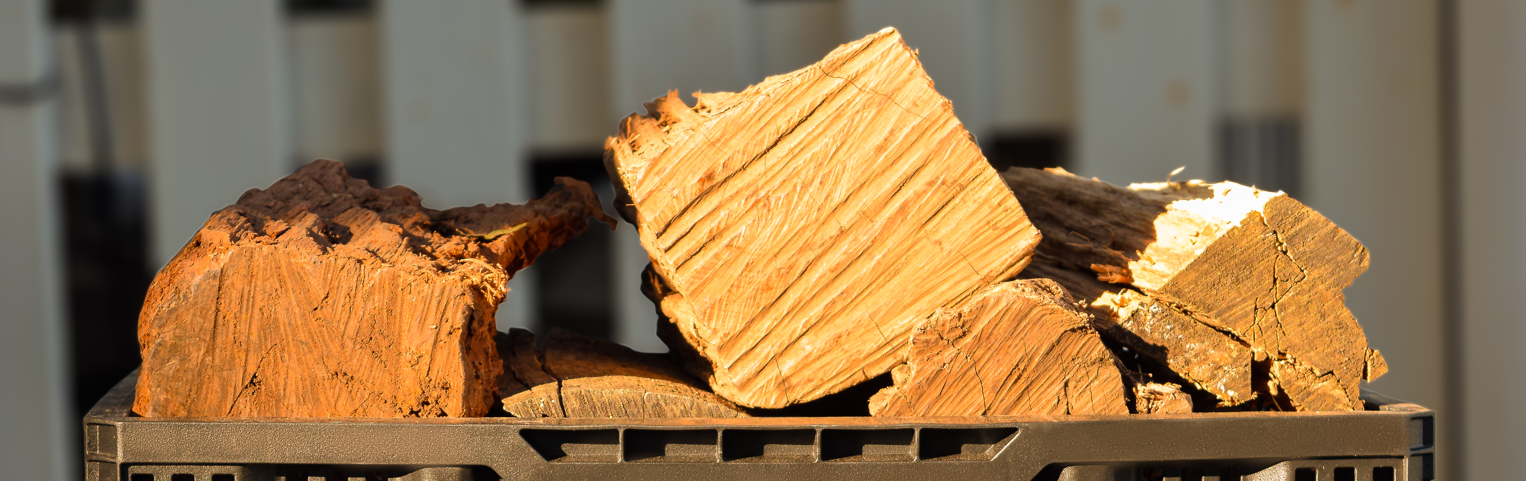 Premium stacked hardwood firewood logs in reusable delivery crates ready for home delivery