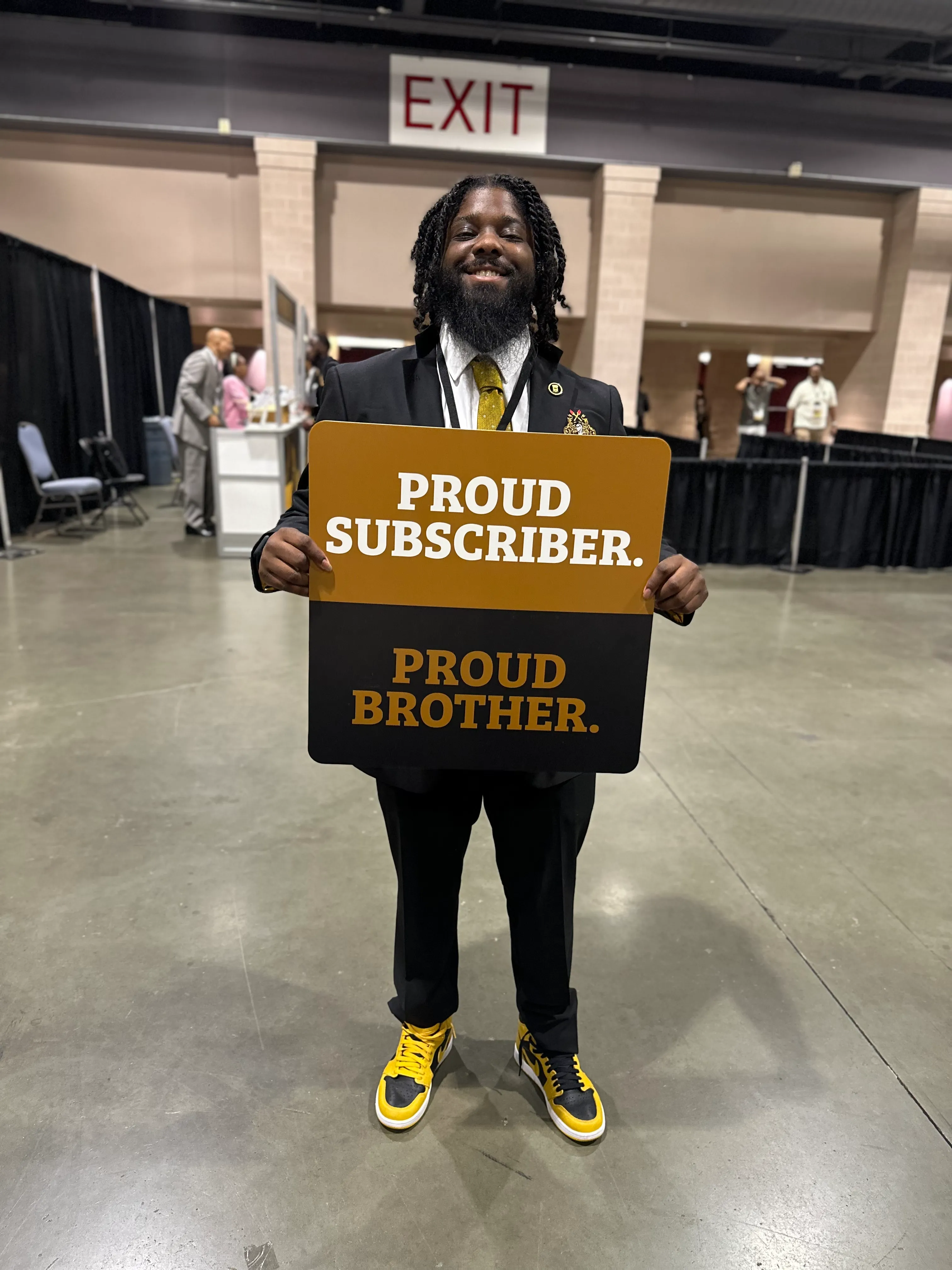 Customer displaying Alpha Traditions gold-accented fraternity accessories with pride