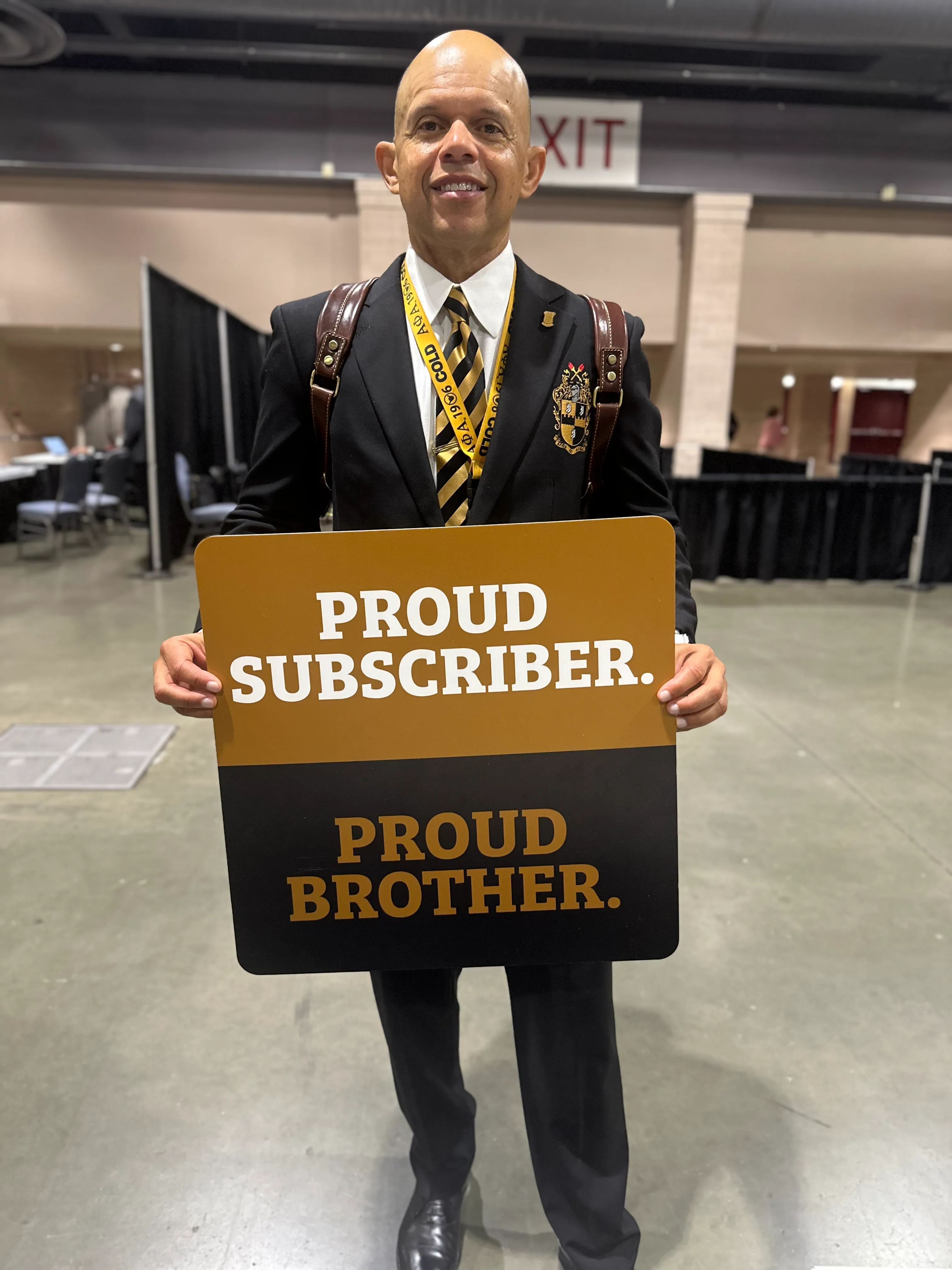 Alpha Traditions subscriber proudly wearing limited edition fraternity jacket outdoors