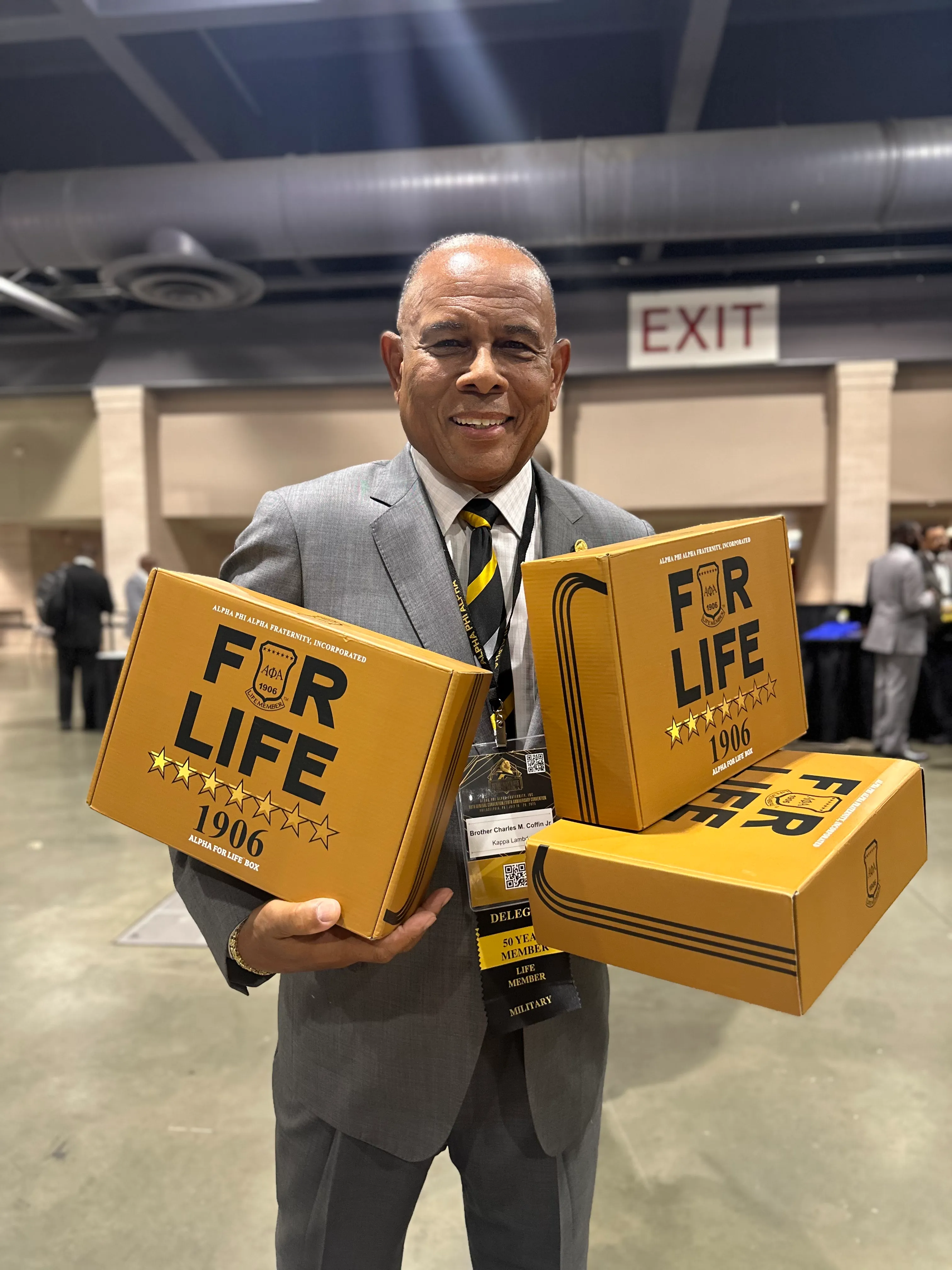 Customer styled in Alpha Traditions premium fraternity hoodie at a community event