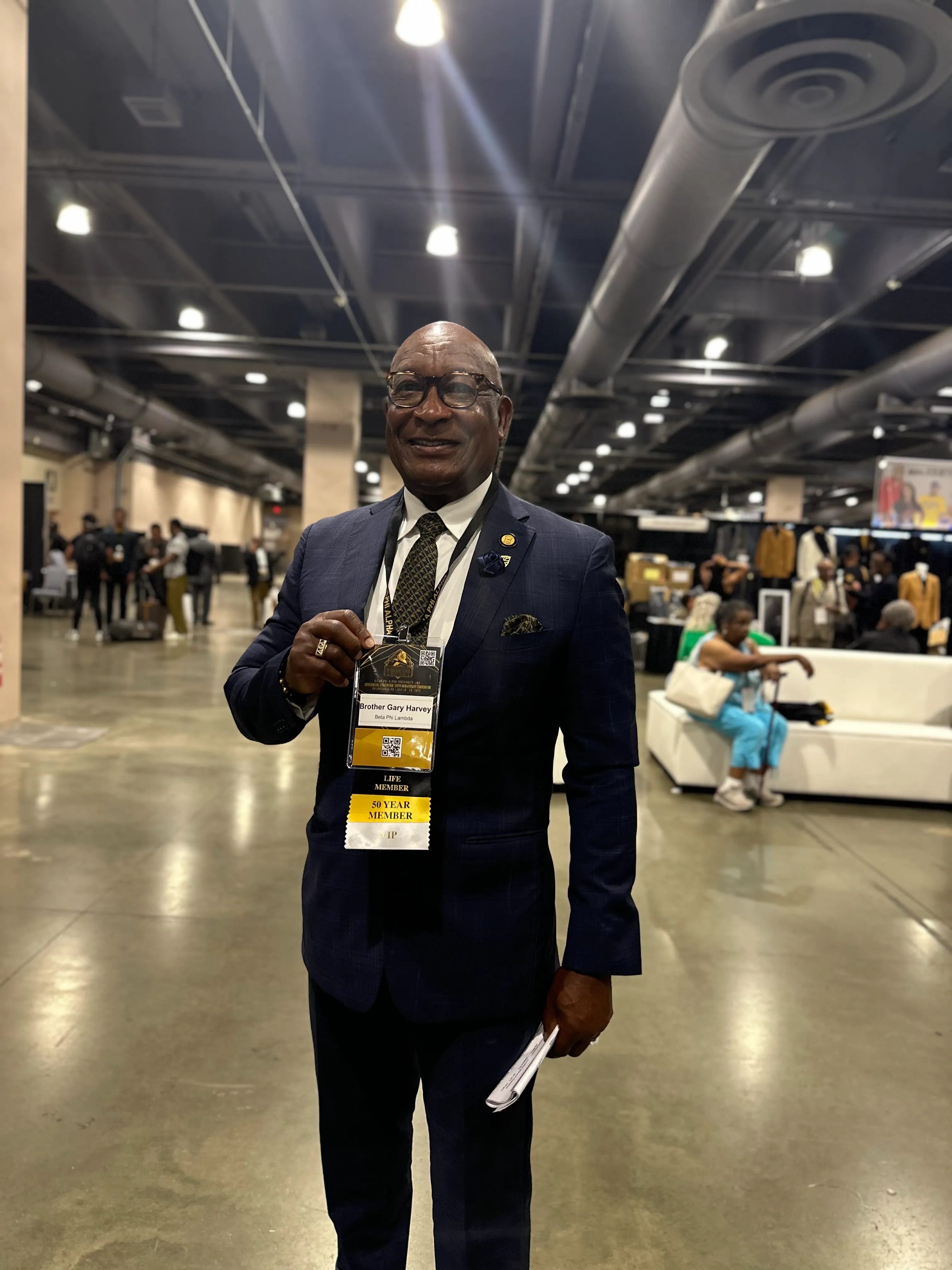 Customer wearing Alpha Traditions gold and black fraternity collection at a formal event