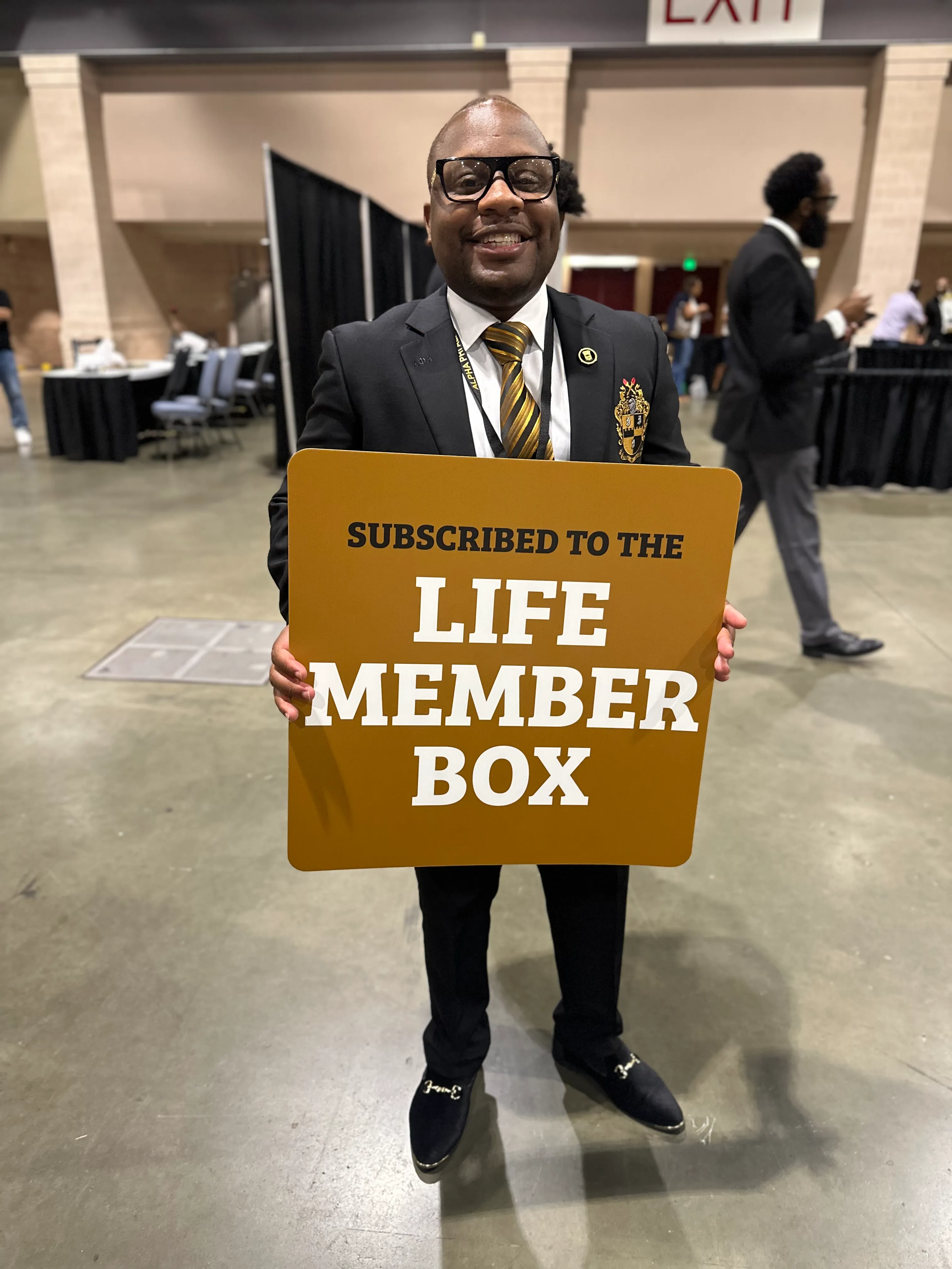 Alpha Phi Alpha brothers celebrating chapter milestones in Alpha Traditions gear