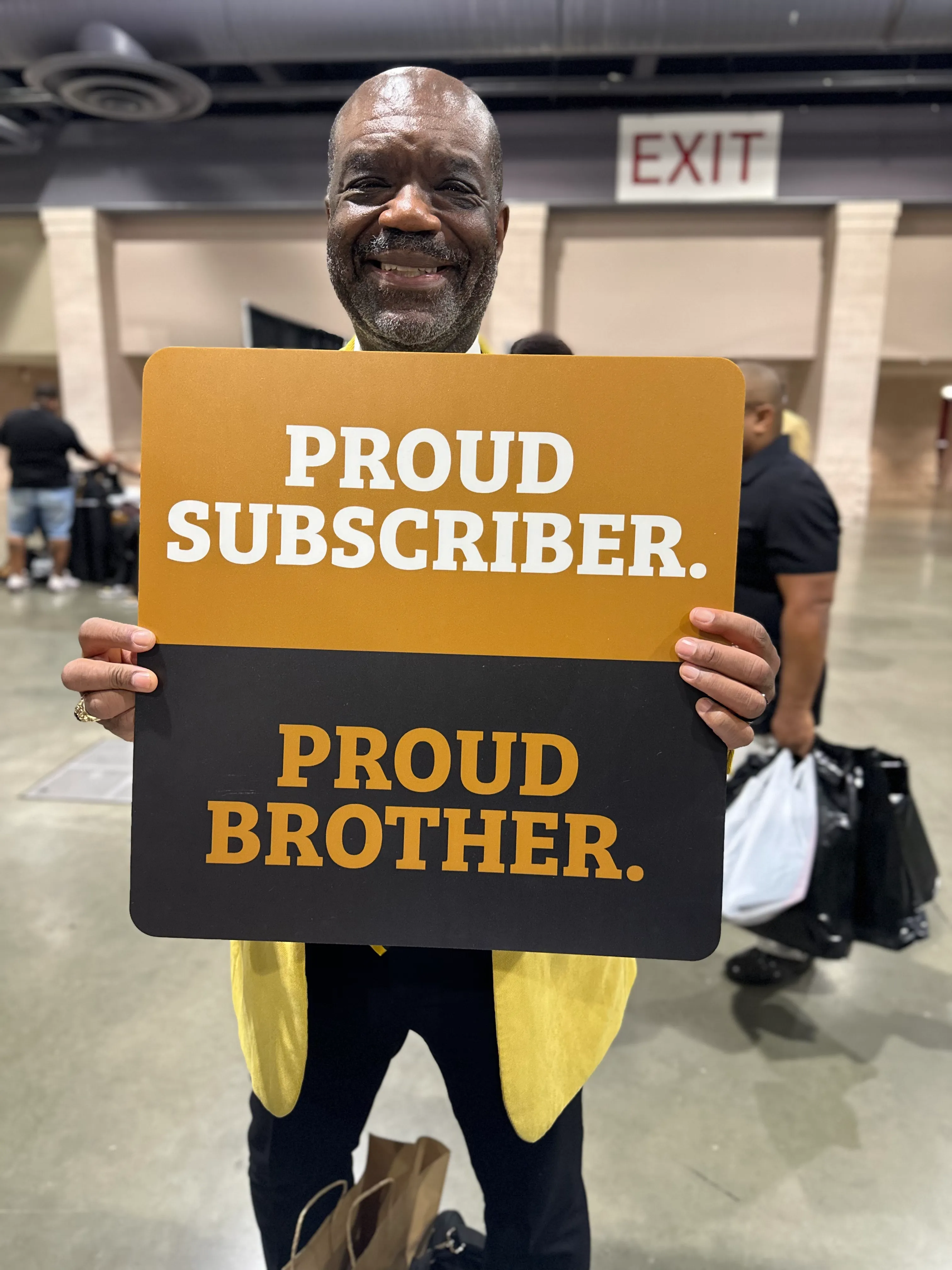 Customer proudly showcasing Alpha Traditions gold-embroidered fraternity polo at homecoming