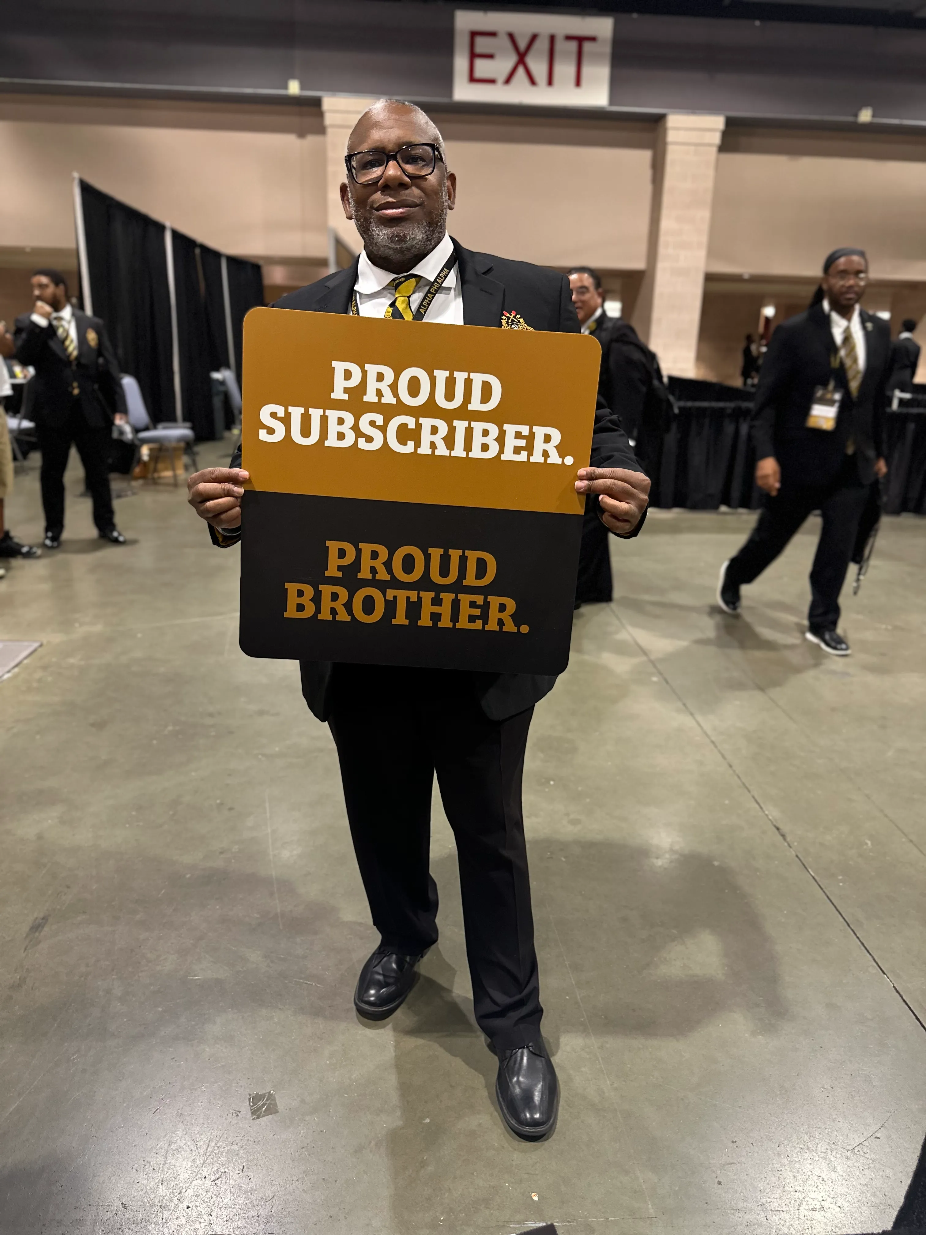 Alpha Traditions member wearing premium gold and black fraternity lifestyle gear