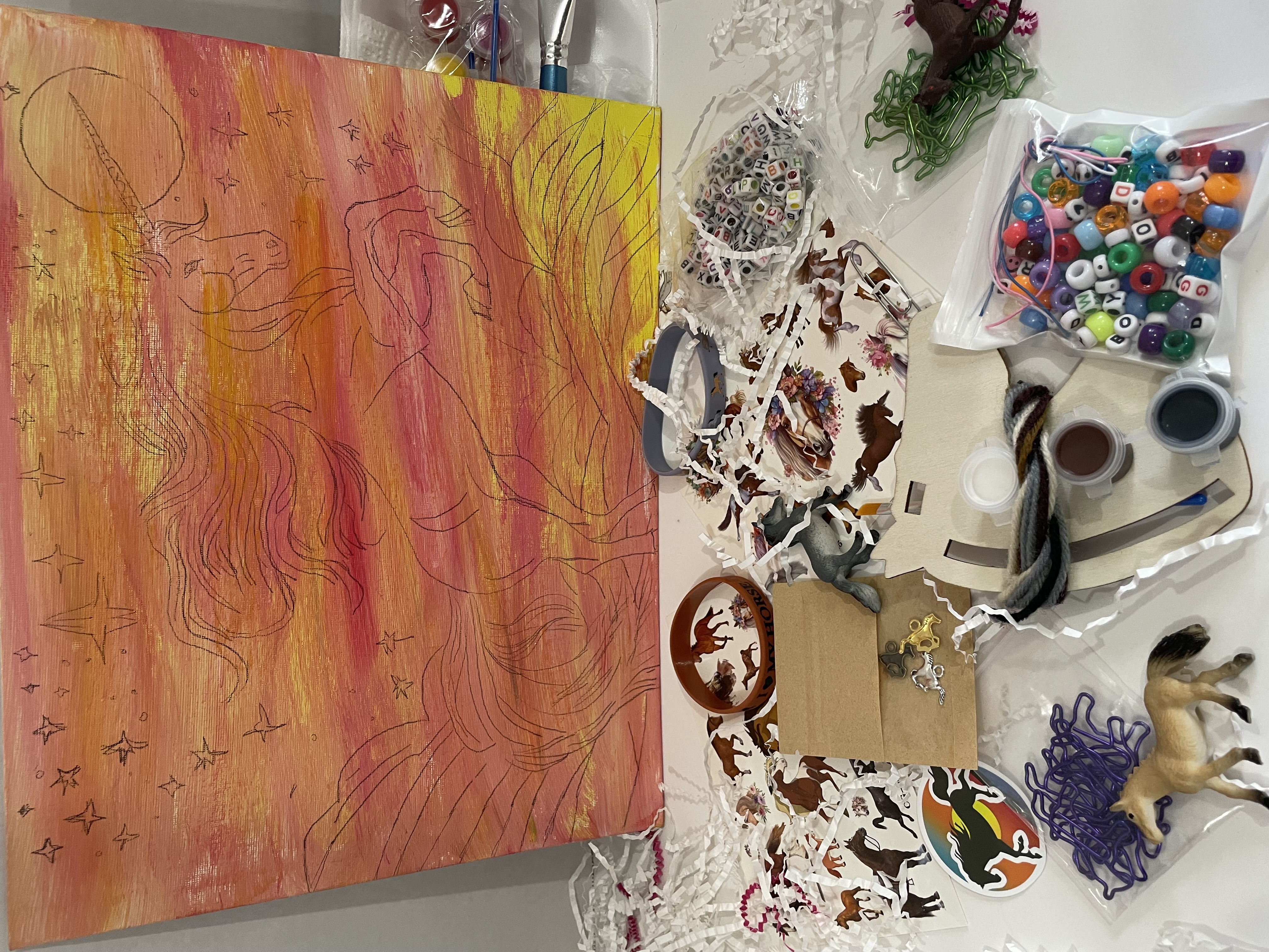 Pony Quest Club crafts with unicorn painting, stickers, beads, figurines, and more