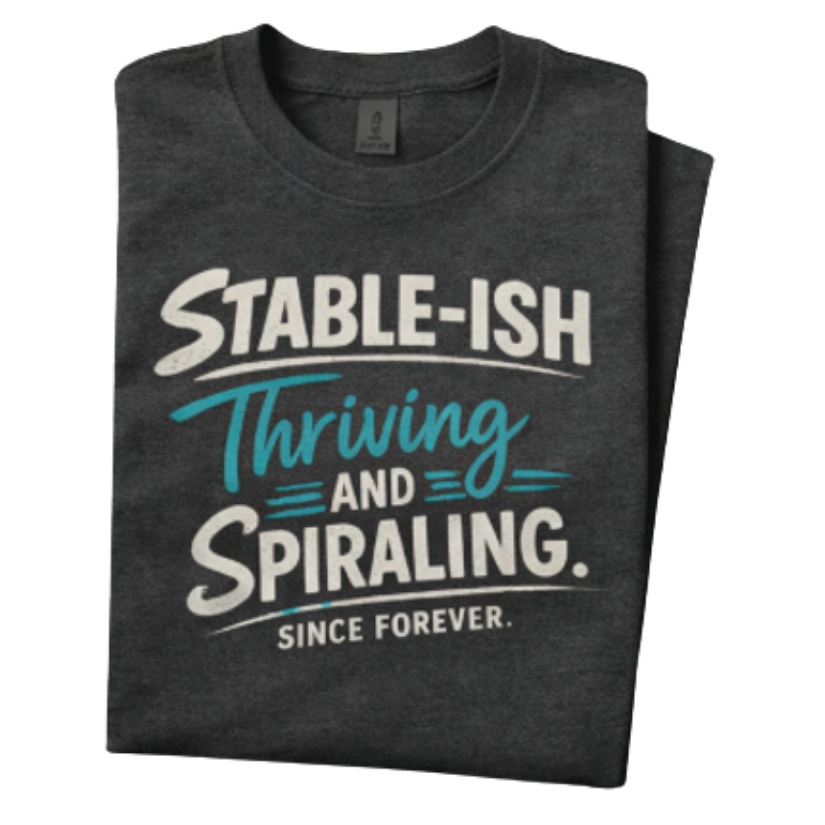 Louder Now statement t-shirt — folded dark gray tee with bold typography