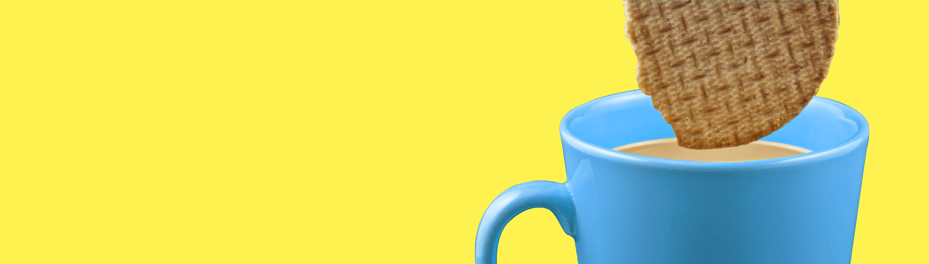 Cookie dunking into a cup of tea