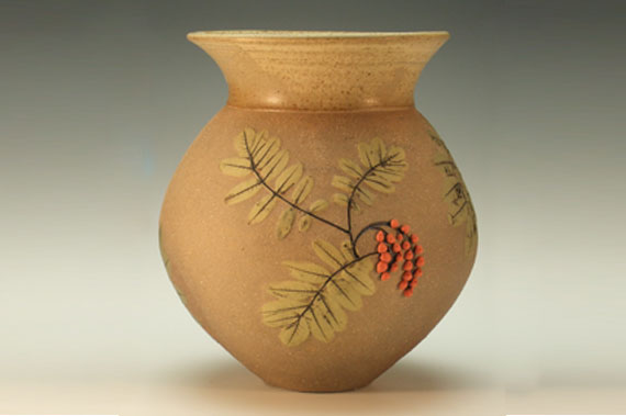 A leaf-patterned vase by Maggie Black