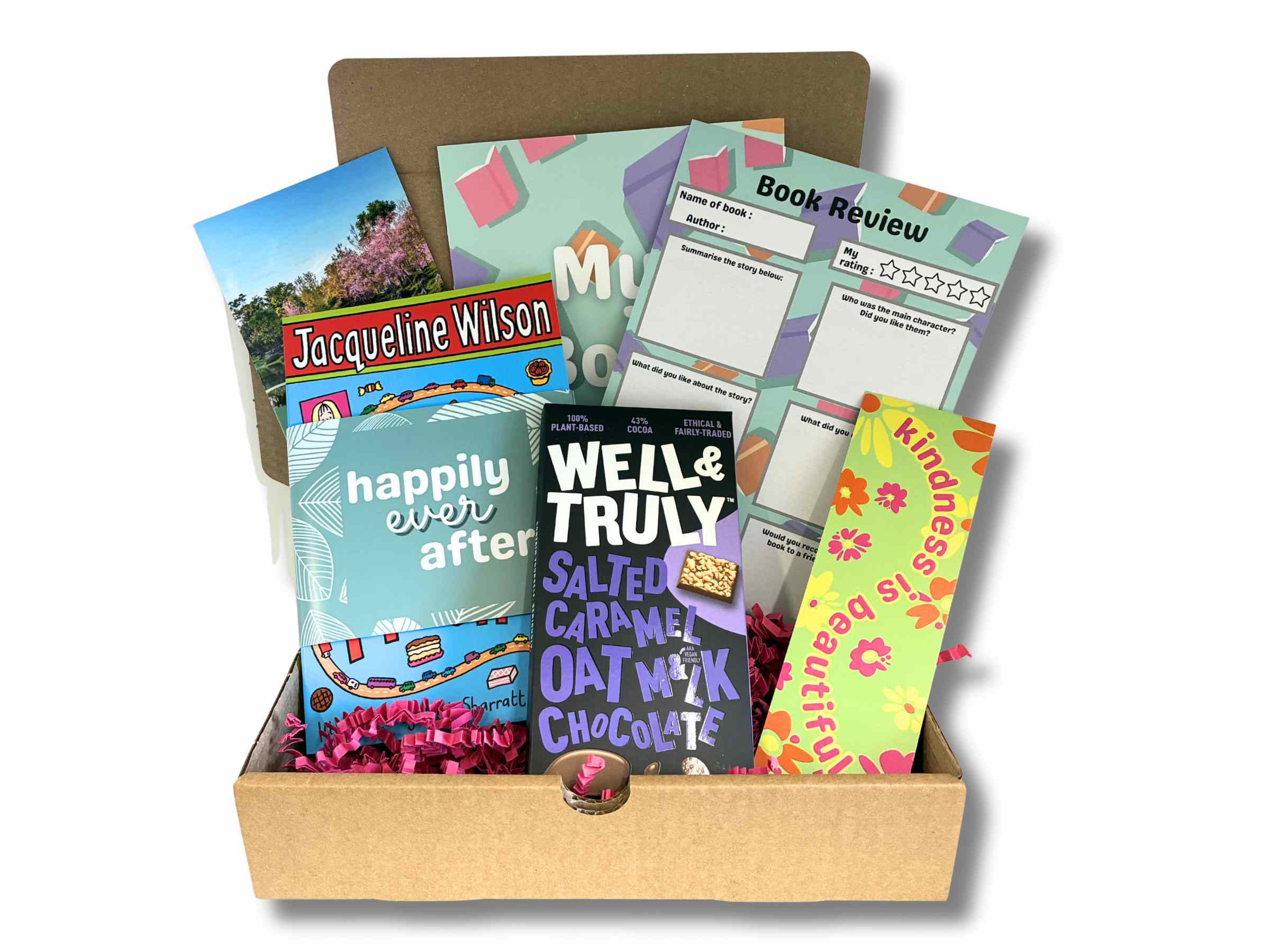 Open children's book box showing a surprise book, bookmark, book review sheet, and vegan chocolate treats