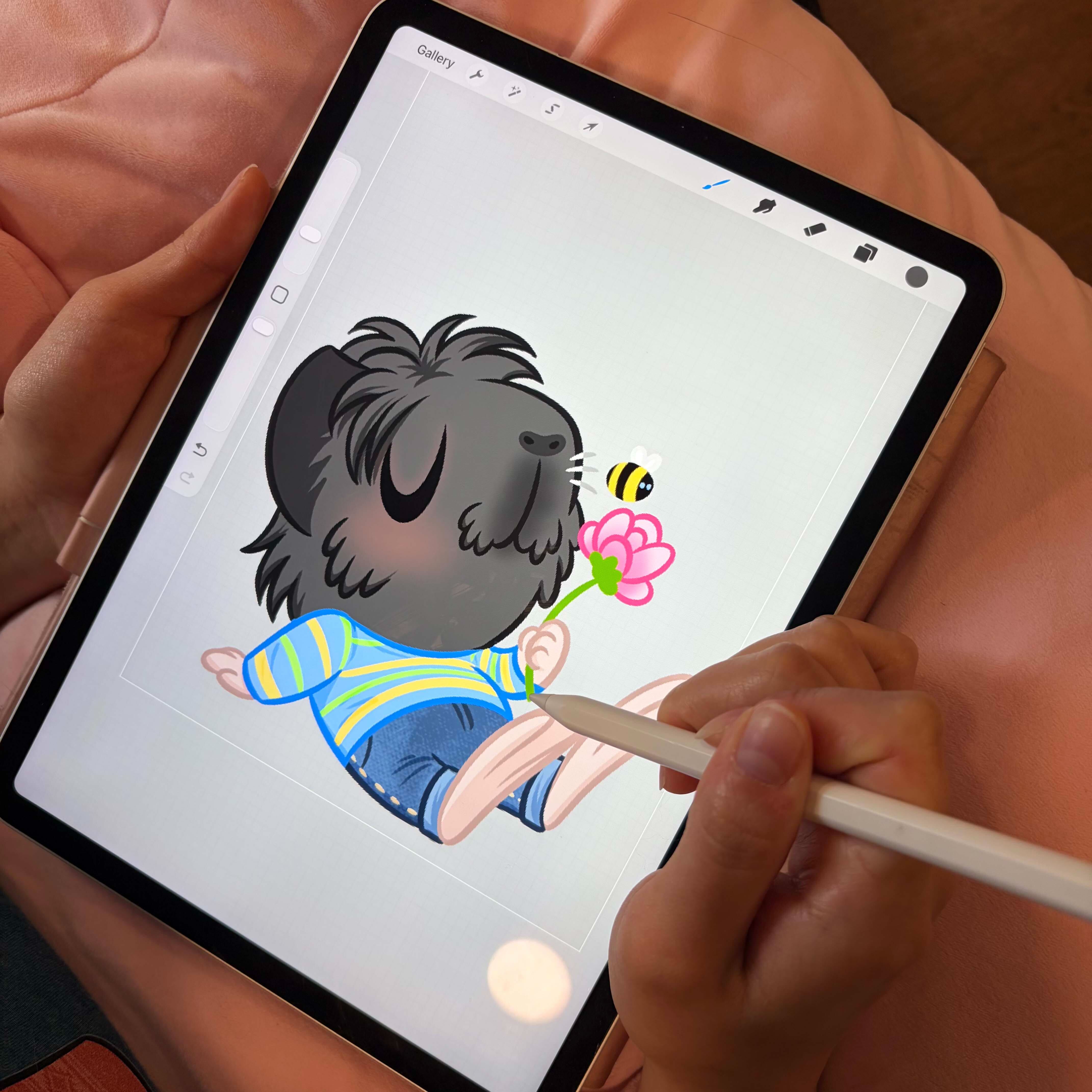 Hand illustrating piggy sticker designs on tablet