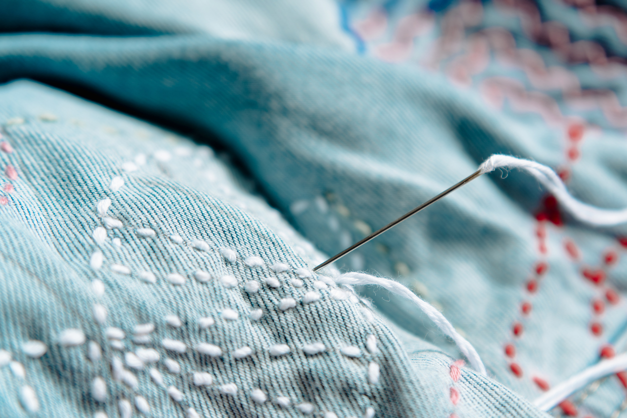 Hand stitching detail on textured fabric