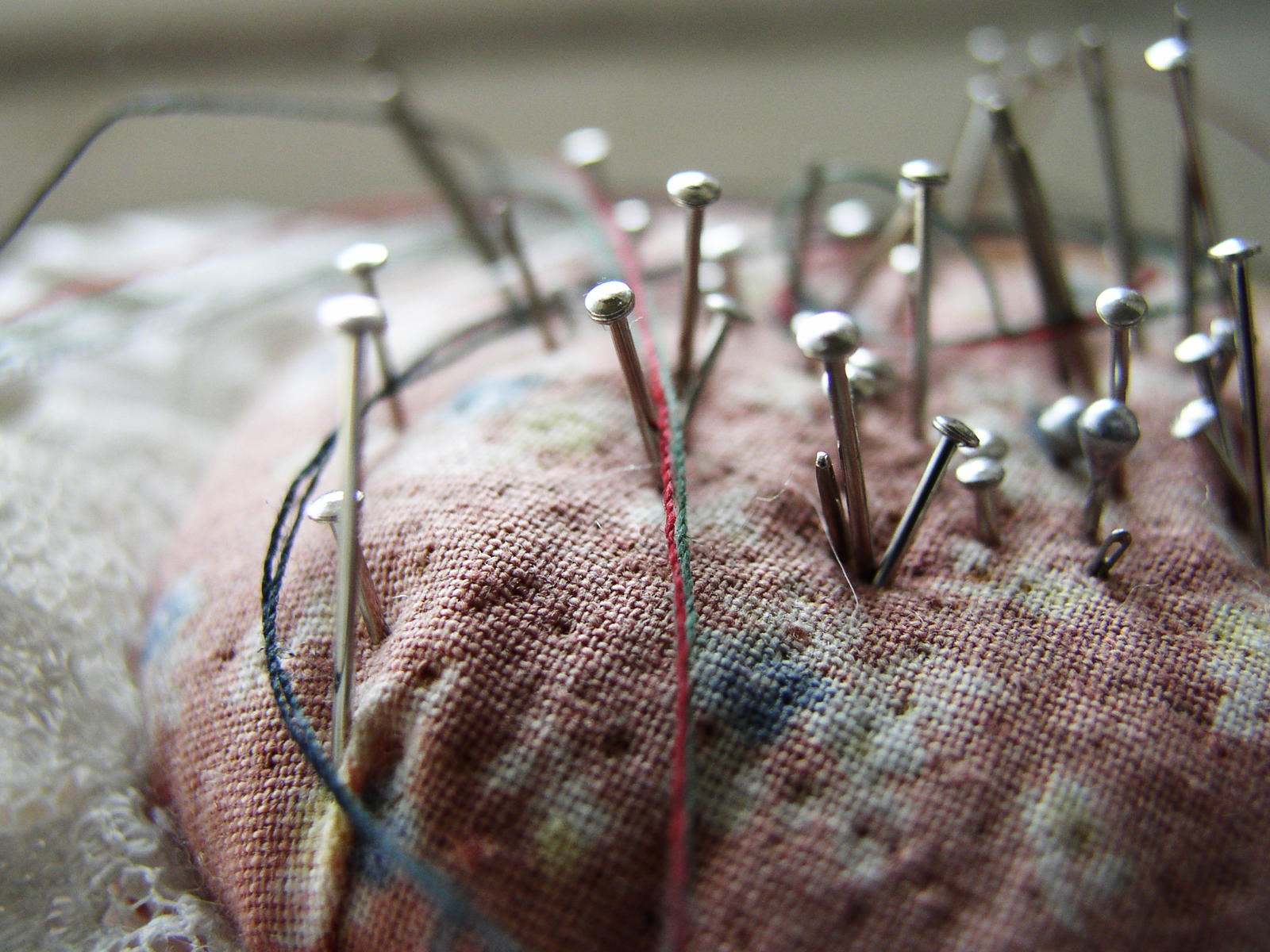 Hands working on a hand-stitched fabric project
