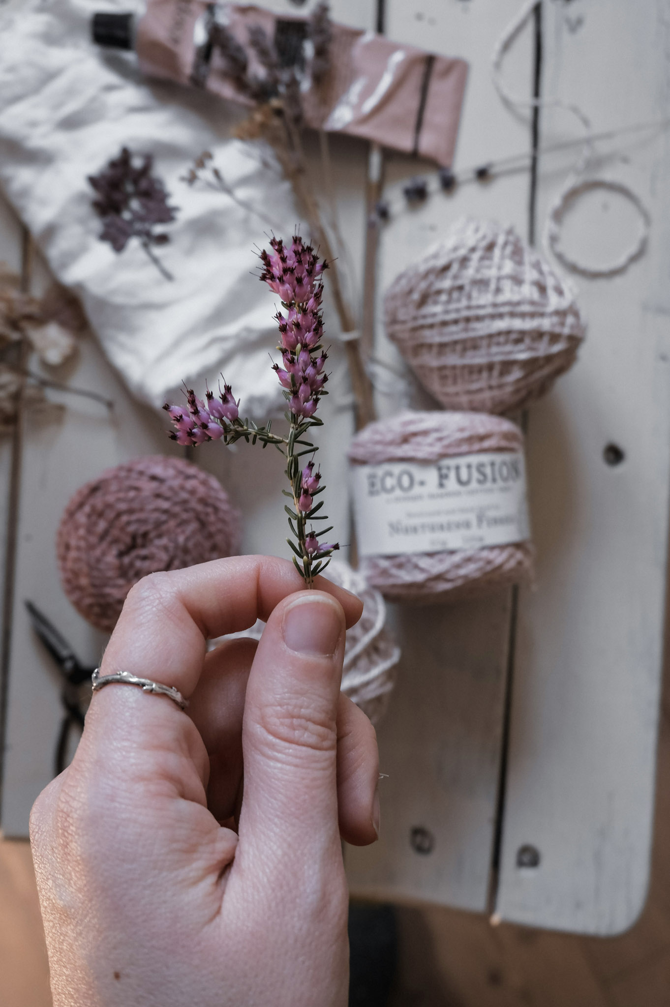 Hands stitching slowly with needle and thread