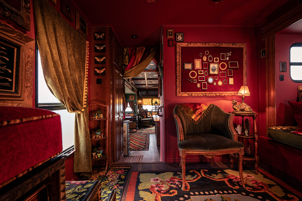 The richly decorated red interior of the Office of Collecting & Design trailer